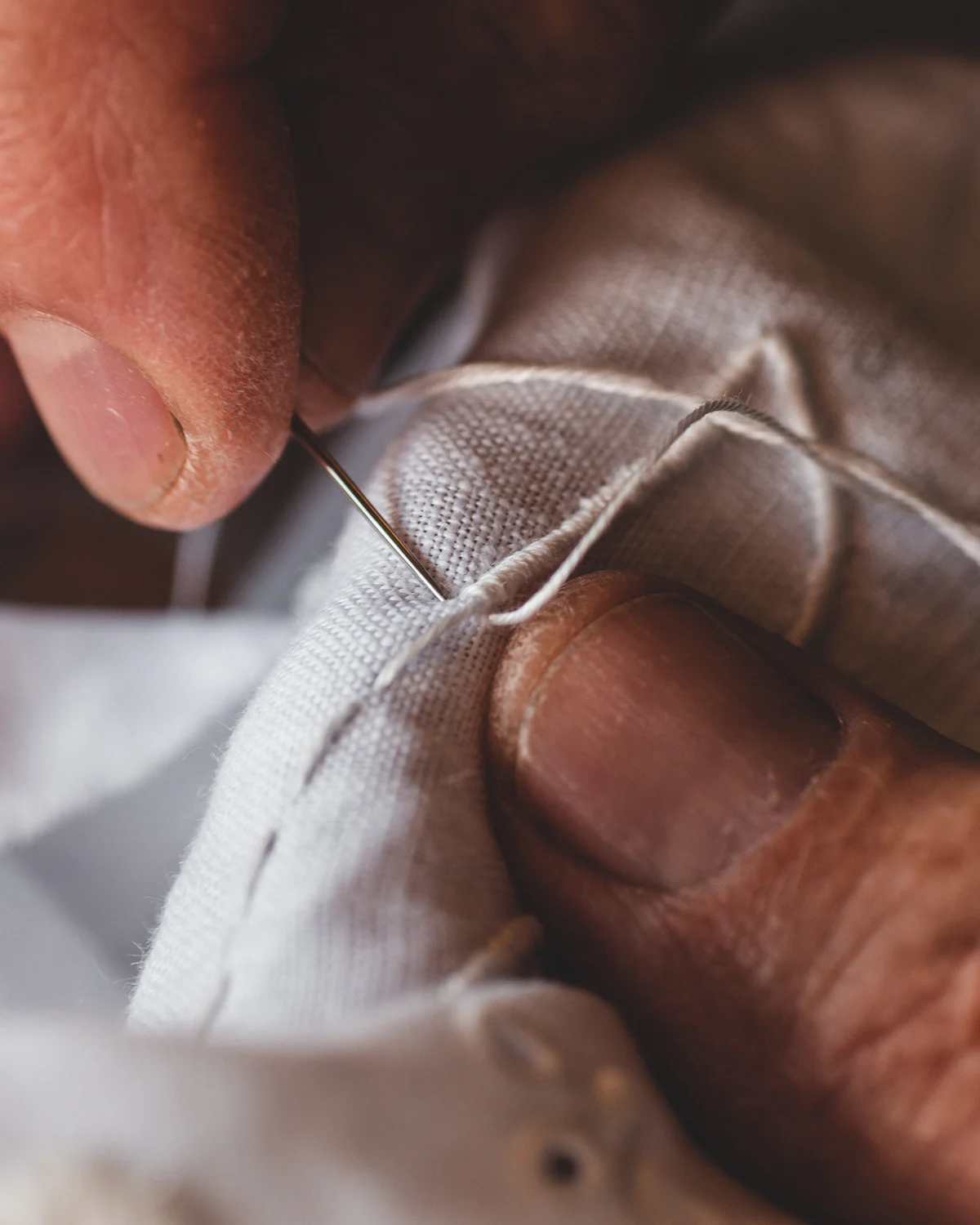 Placeholder: hands at work, standing in for the cotton-blend and faux fur layers being prepared.