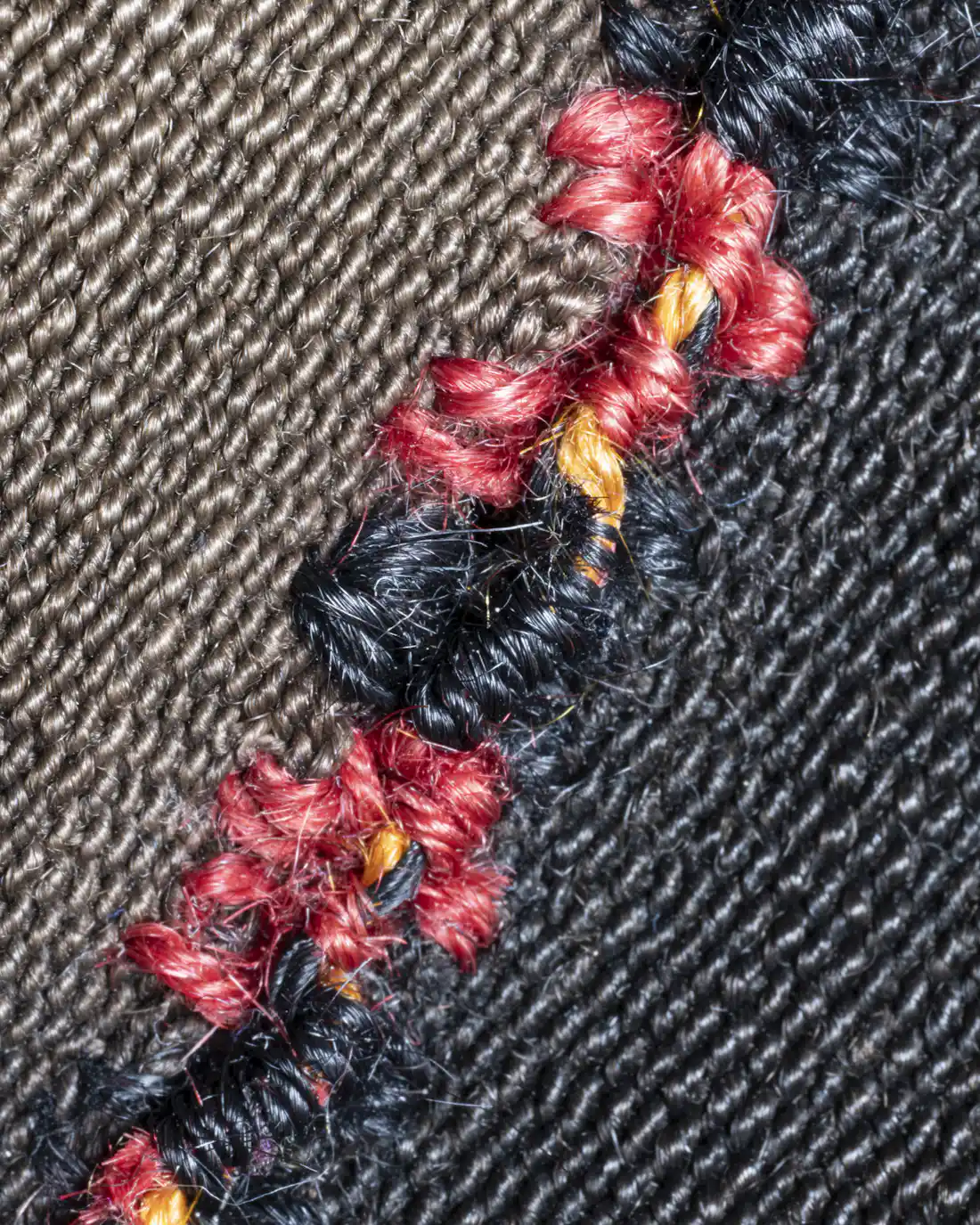 Placeholder: stretched textile macro, standing in for the thread tension being set by hand.